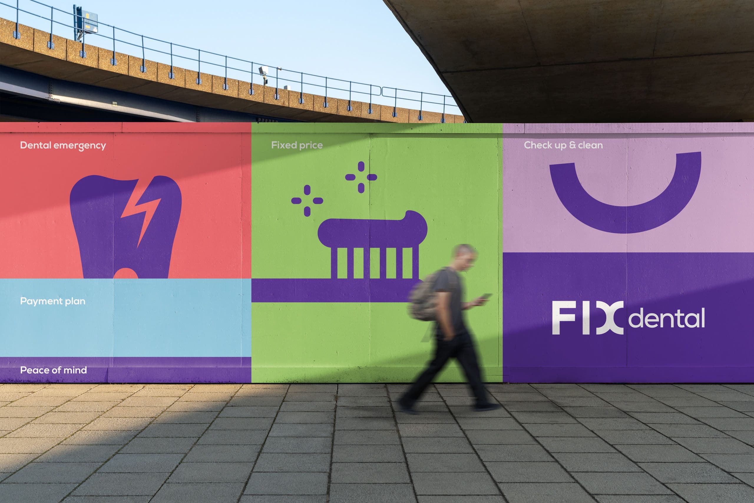 Fix Dental branded billboard hoarding with man walking in front