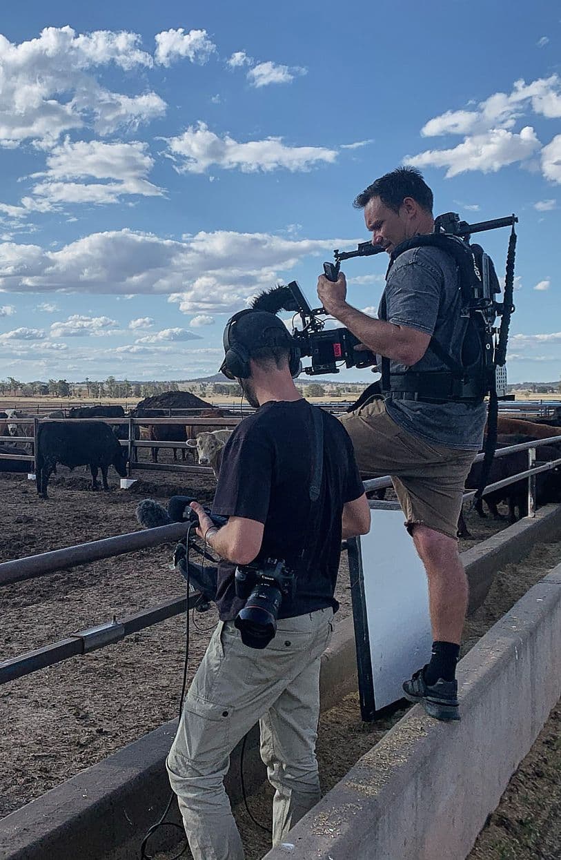 Videographer & Photographer on set filming/shooting at a farm